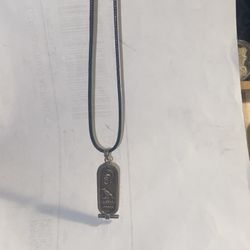 Black 20 inch leather necklace with two pendants once a sterling silver Egyptian pendant and the other one is a hand poured lizard