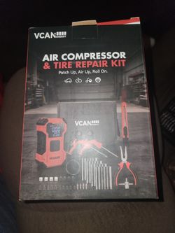 Portable air compressor with tire repair kit