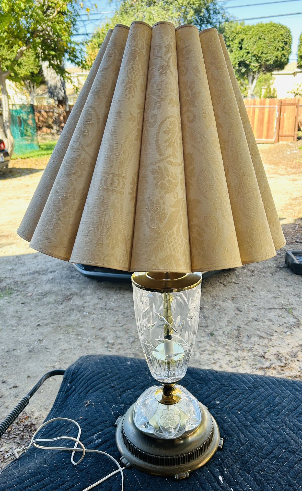 This is a vintage crystal table lamp with a pleated, ruffled lampshade