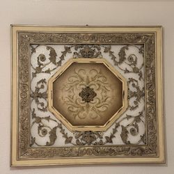 Decorative gold-toned wall piece, very detailed. 