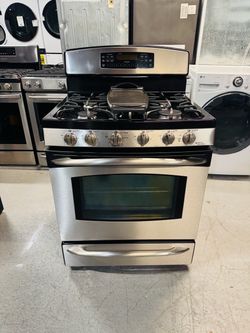 GE natural gas range with double oven, stainless steel; includes a receipt for a 60-day warranty.