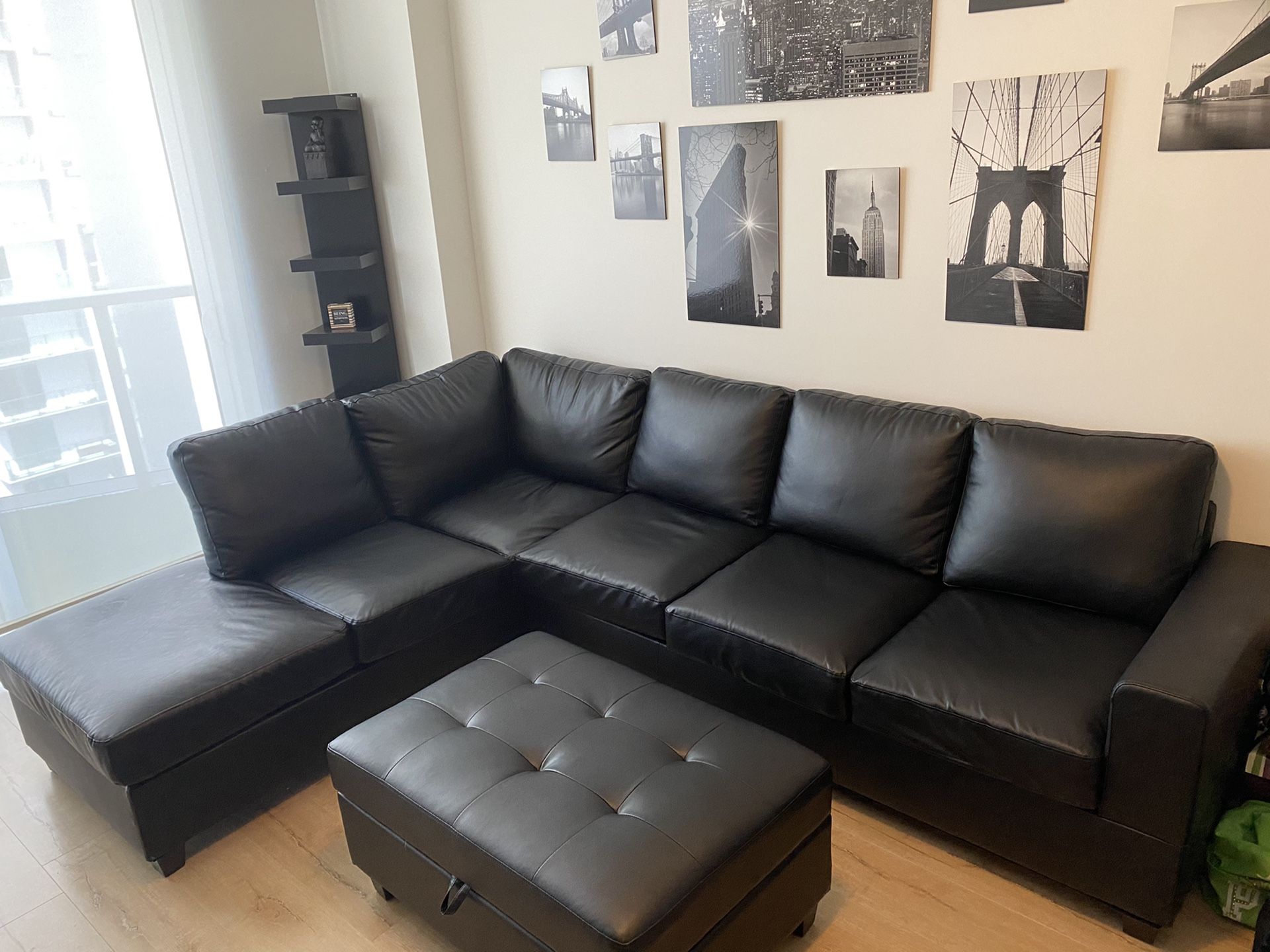 Black sectional with black storage ottoman