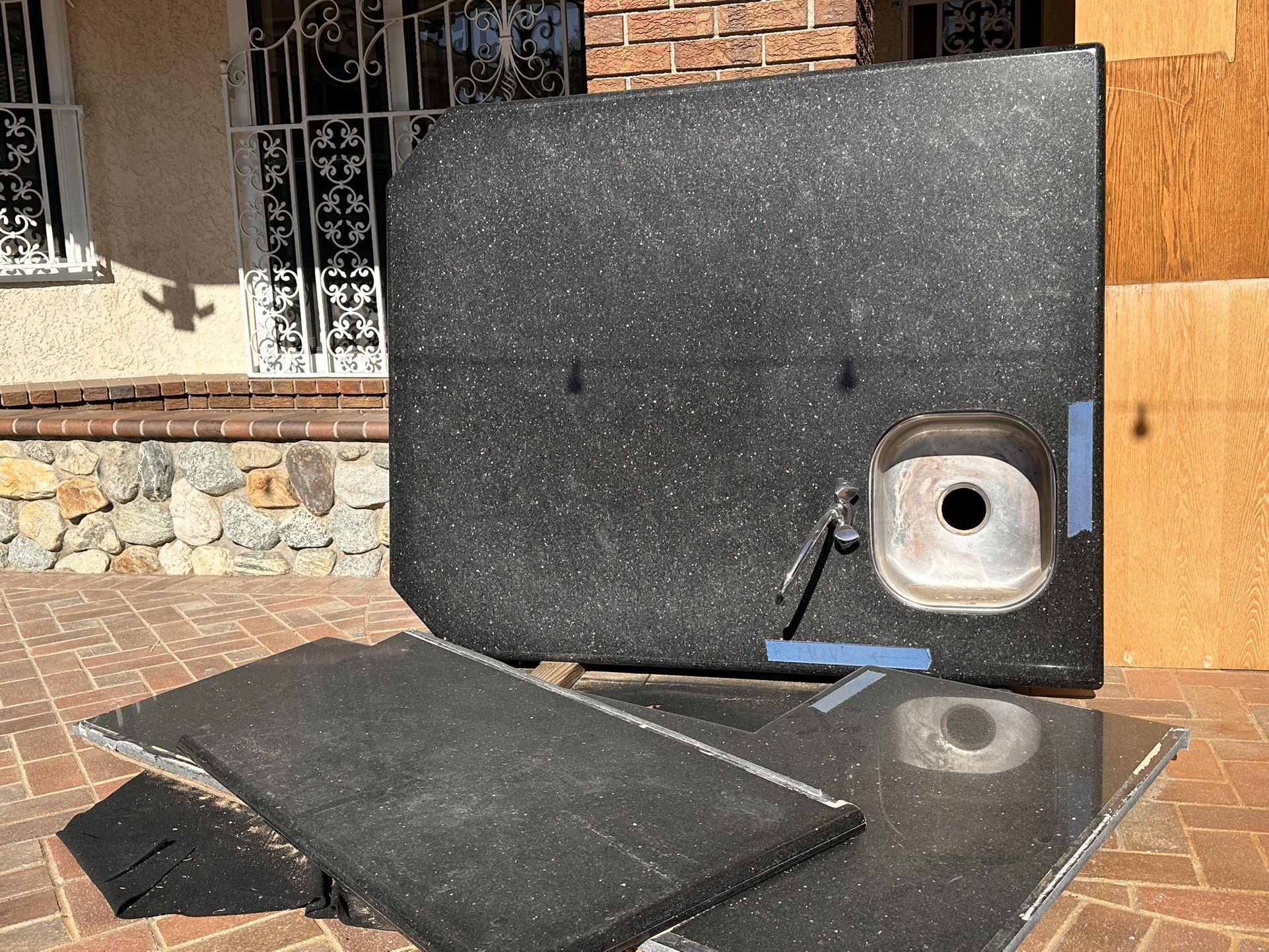 Black Galaxy granite countertops with a stainless steel drop-in sink.