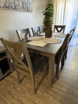 Gray dining table with six chairs