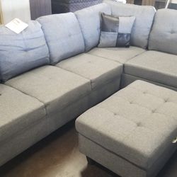 Light bluish gray sectional with a matching storage ottoman