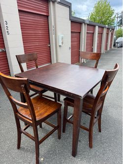 Square wooden high table and four chairs