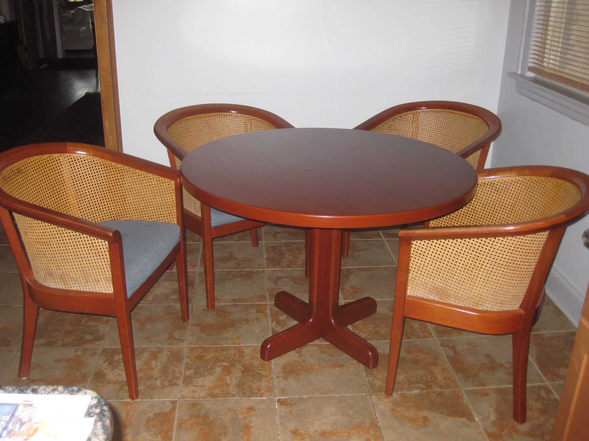 4 wood and cane back chairs with matching solid wood table