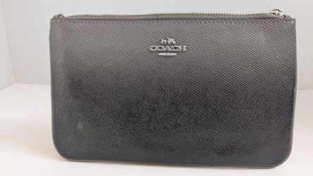 Coach Corner Zip Wristlet made of textured leather with silver-toned hardware. 