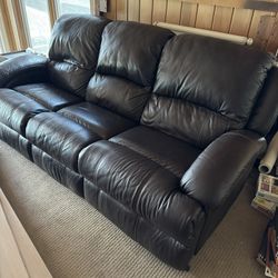Large dark walnut brown leather couch with reclining seats on each end 84" wide x 39" tall backrests x 40" deep.
