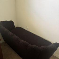 Black couch with gold legs