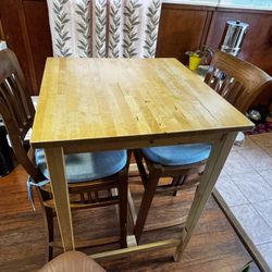 IKEA table and two antique wood chairs