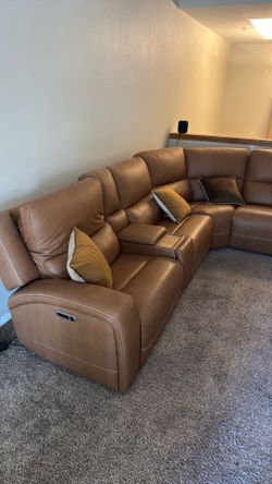 New living spaces, leather sectional couch with three powered recliners