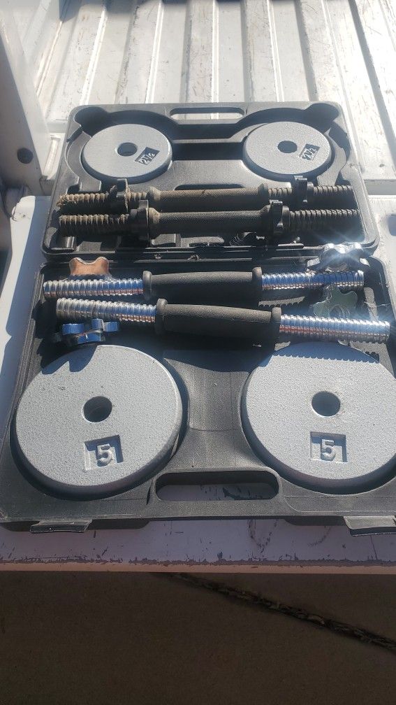 A Lot Of Different Weights Plates And Barbell And Curl Bars