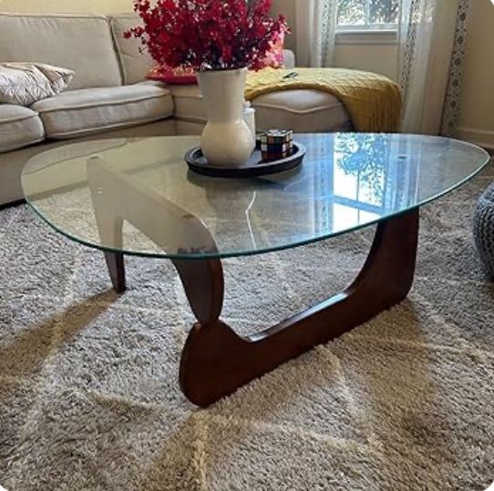 Lightly used Coffee Table. Solid Wood legs with Tempered Glass Top & Adjustable Base