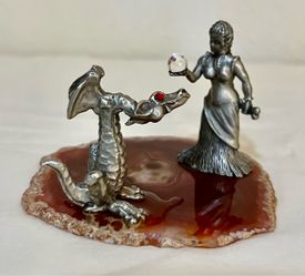 vintage 1980s or 1990s solid pewter fantasy display, featuring a detailed sorceress figurine presenting a clear crystal sphere to a sitting dragon wit