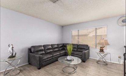 Black leather couch with glass tables