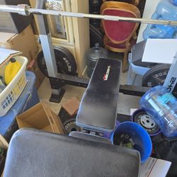 Bench with barbell, plates and leg curl