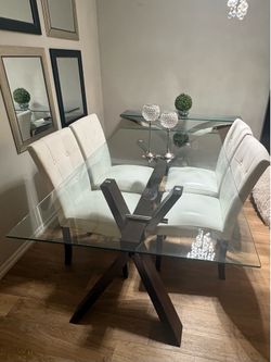Dining table with four chairs (seats up to six) and a metal and glass console table.