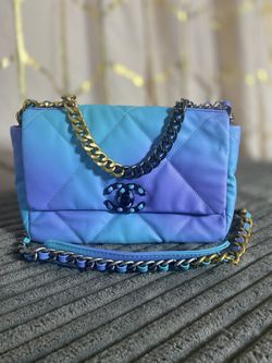 Blue And Purple Purse With A Leather Chain Strap