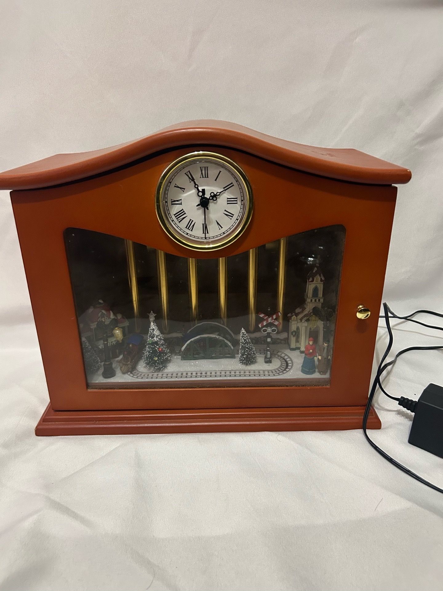 Mr. Christmas Gold Label animated musical chimes clock featuring a rotating train scene
