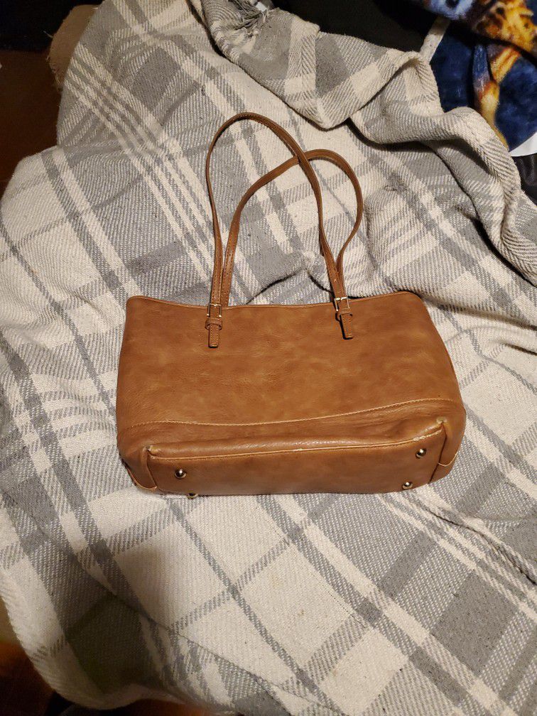 Light Brown Urban Expessions Purse.  Inside  is black and white stripped .  There is some wear on the  bottom.