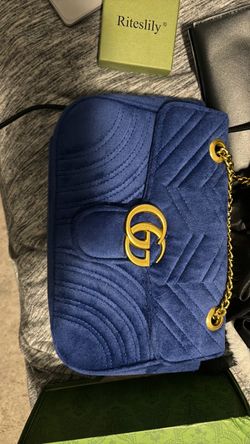 Gucci royal blue velvet GG Marmont shoulder bag featuring chevron quilting and antique gold-tone Double G hardware.