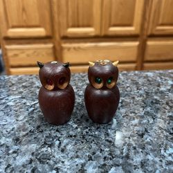 Vintage Wooden Owl Pair of Salt and Pepper Shakers.  One owl has Red eyes the other has Green eyes.  Size approximately 2 1/2 inches tall.  Preowned n