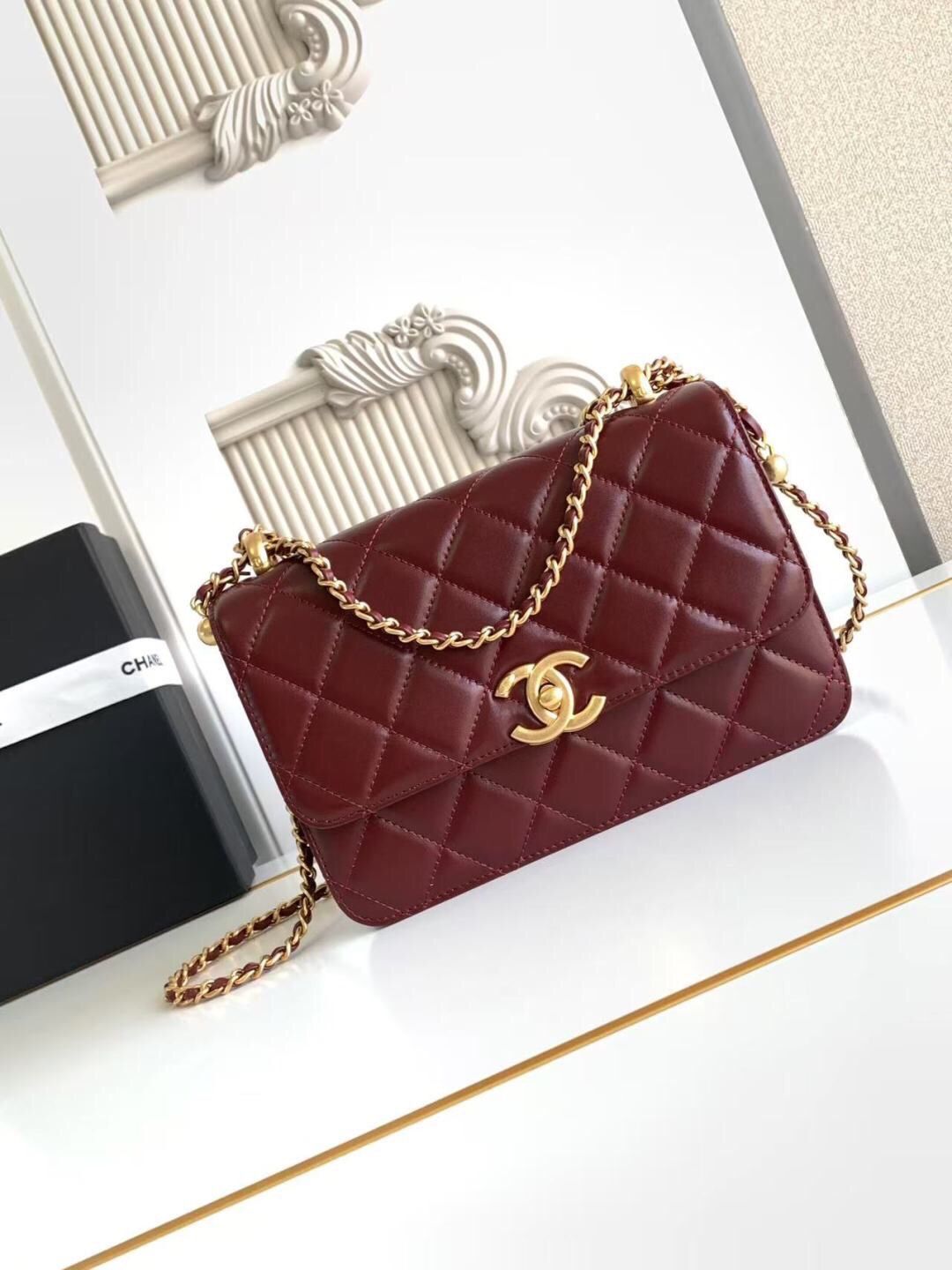 A fashion trend bag with a golden ball