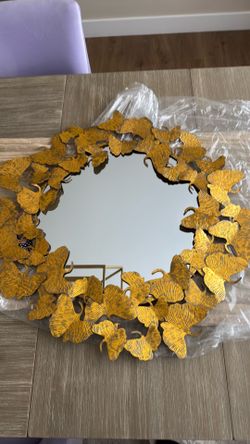 TWO lyrical gold round wall mirrors