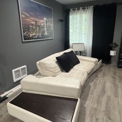white leather sofa with end tables . 