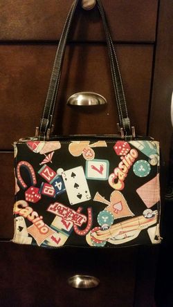 Casino purse with jewels on one side and leather straps