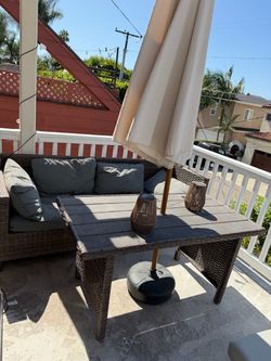 7 piece outdoor sofa set - 1 table, 2 couches, 2 ottomans, 1 umbrella, and 1 umbrella stand