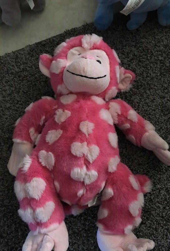 Stuffed Monkey with hearts all over it.