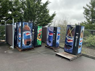 Several Coin Op Soda Machines