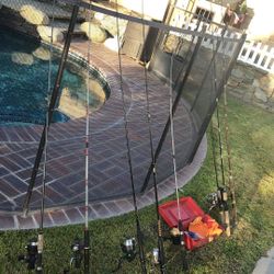 EIGHT FISHING RODS WITH REELS PLUS A SMALL RED TACKLE BOX