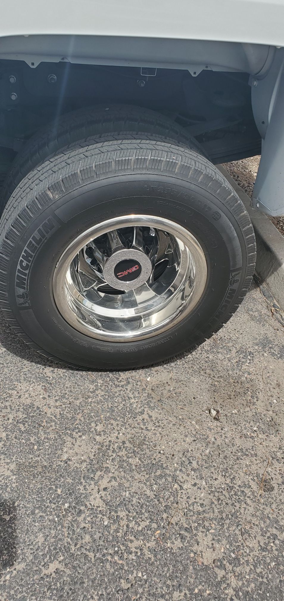 2015 GMC stock aluminum rims and tires with chrome simulator covers
