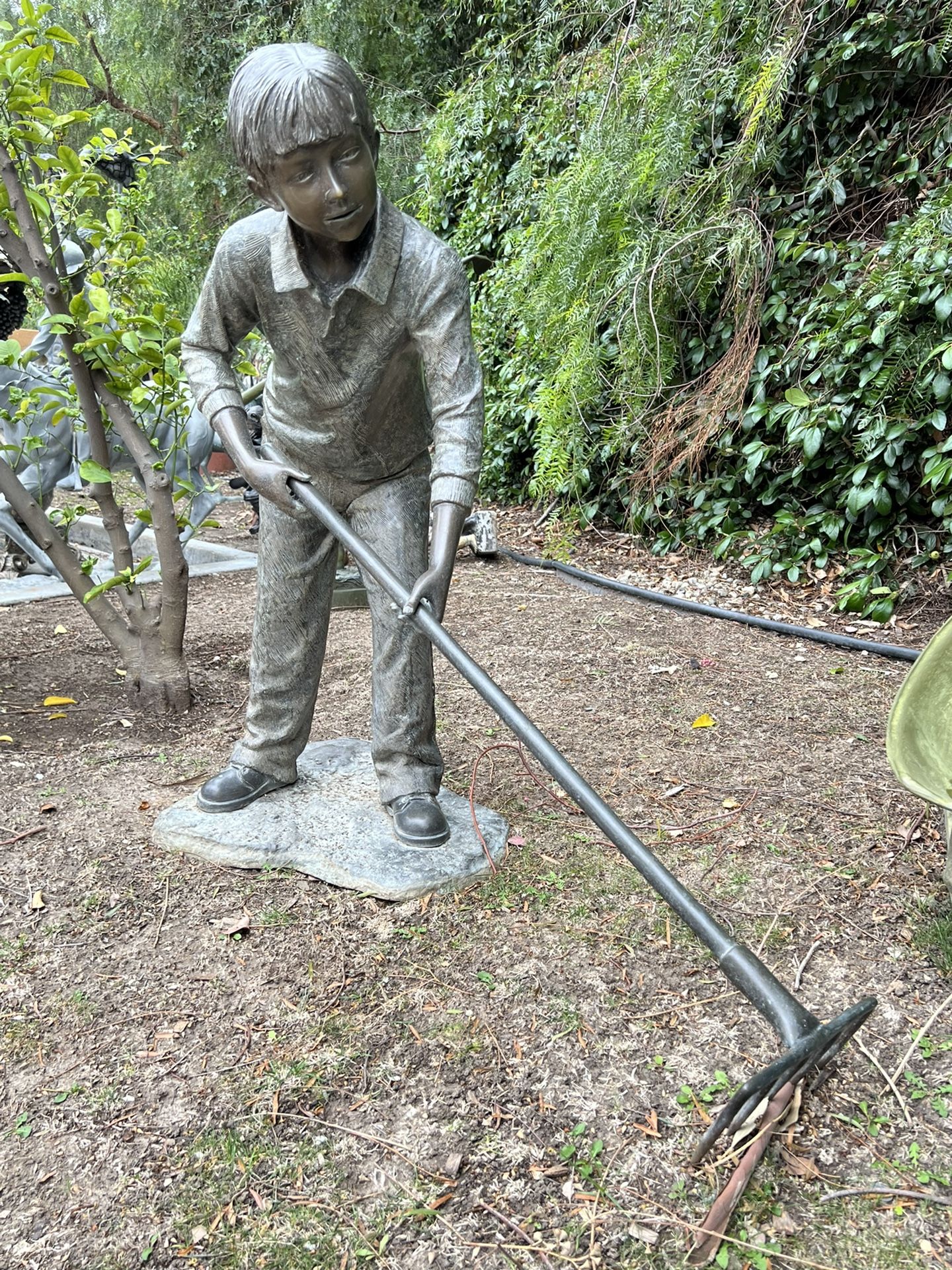 Bronze Boy Cleaning Leaves