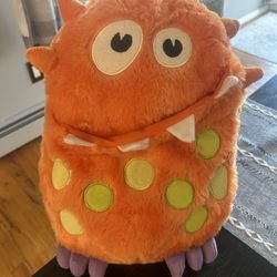 Orange and green monster plush toy 