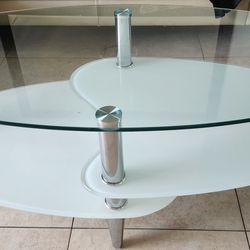 modern oval glass coffee table with a frosted lower shelf and metal 