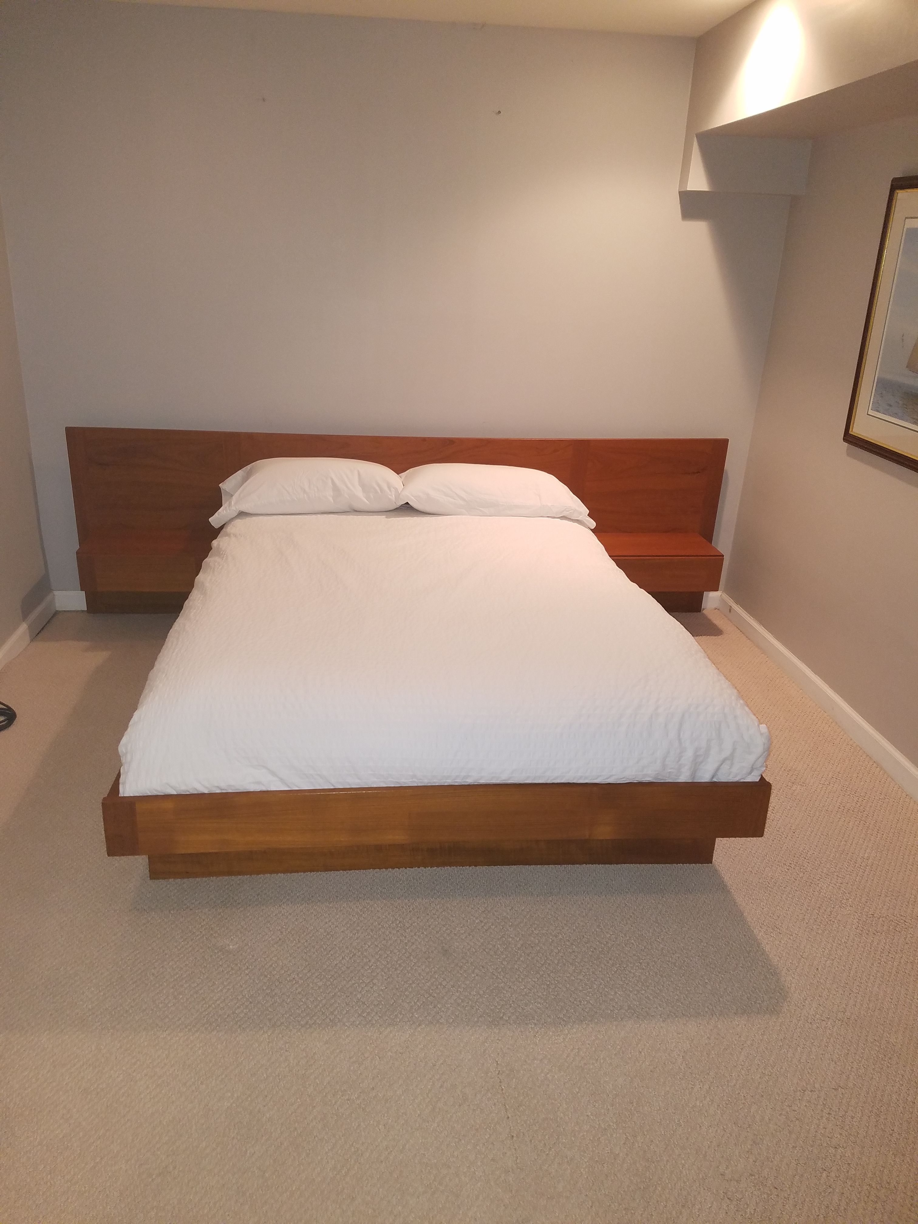 Teak platform bed with floating nightstands