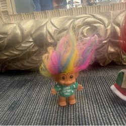 The selected region features a vintage 5-inch Russ Berrie Christmas Caroler Troll Doll with bright red hair, green earmuffs, and a holiday outfit hold