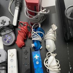 WII console + four controllers and 3 attachable controllers + 7 games