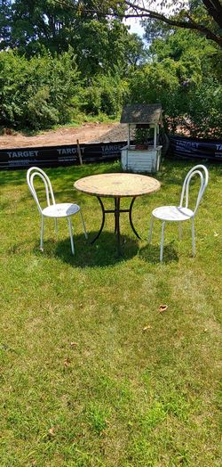Table. 2chairs. And umbrella stand