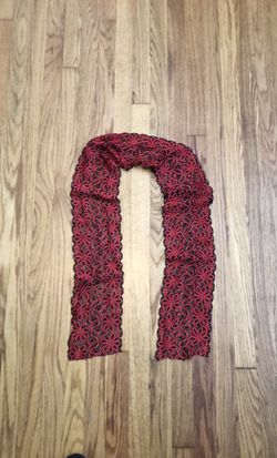 Beautiful red and black partially sheer lace scarf. Could also be tied around the waist as a belt or tied on a bag/purse or even in your hair