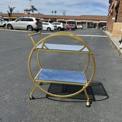 Round gold bar cart with mirrored shelves