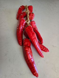 Ceramic red chili pepper strand on a juted rope