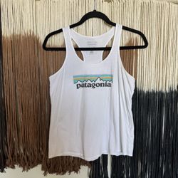 White Patagonia tank top with purple, orange and green logo; perfect condition