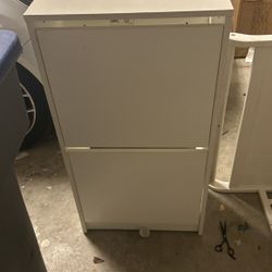 White Cabinet With Swing Drawers Great For Baby’s Room Next To A Changing Table