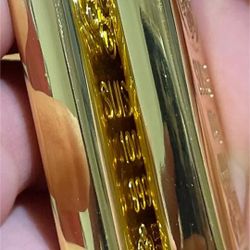 REPLICA / NOVELTY 100-gram gold bar–style prop. 