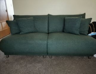 Wool green sofa with four throw pillows